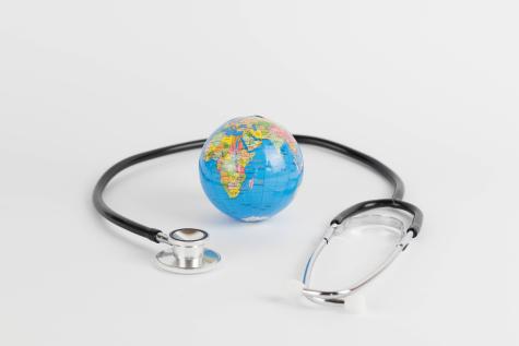 Image of a stethoscope surrounding a small globe