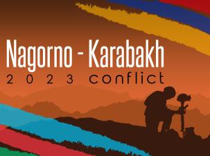 Soldier kneeling with sunset in background.