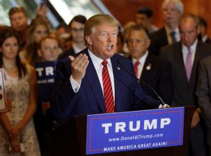 Donald Trump gives a public speech in front of a large crowd 