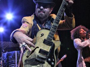 Dave Stewart performs at the Sydney Entertainment Centre. He poses to the camera putting his guitar close to the lens.