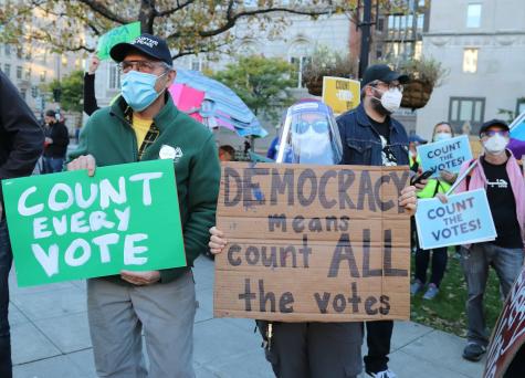 2022 protest in Washington, DC to support democracy and the fairness of elections. Many protesters hold signs which read 'Count every vote.'