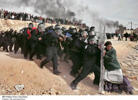 A Jewish settler struggles with an Israeli security officer during clashes that erupted as authorities evacuated the West Bank settlement outpost of Amona