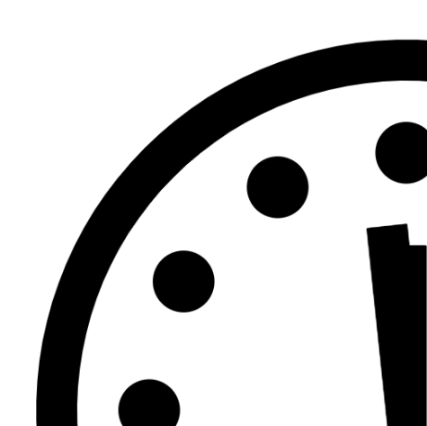 Black and which image showing the top left quarter of a clock. In this Doomsday clock, the hands are positioned at 1 minute to midnight