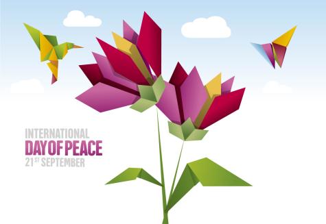 International Day of Peace poster featuring pink, orange, and red origami flowers and birds with the text 'International Day of Peace 21st September' written in pink and grey to the left