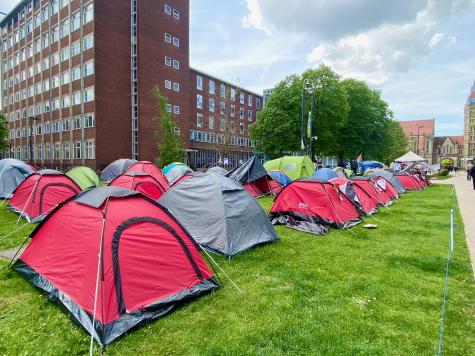 Different colour tents are neatly lined up on a park in the heart of the University of Manchester campus. This is part of the occupy campus movement to protest the universities financial ties with Israel 