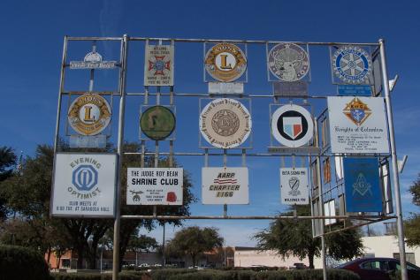 Large metal frame containing the logos on 15 services clubs