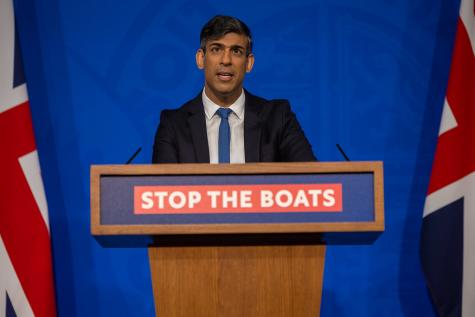 The Prime Minister Rishi Sunak holds a press conference on migration in Downing Street, he stands behind a podium which says 'Stop the Boats' with two Union Jack flags on either side