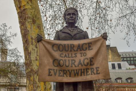 Statue of feminist and Suffragette Millicent Fawcett. She is holding a sign that says 'Courage calls to courage everywhere'