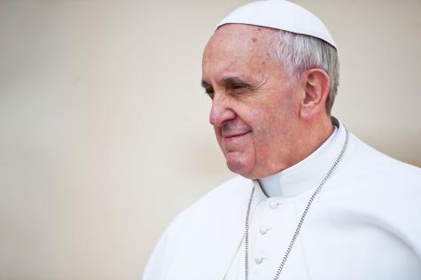 Side profile of Pope Francis wearing his white traditional ropes.