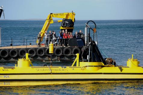 Scotrenewables Tidal Power project a commercial-scale floating tidal turbine floats next to a jetty with many onlookers