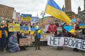 Residents of Glasgow hold posters and UKrain flags showing their solidarity for Ukrainians